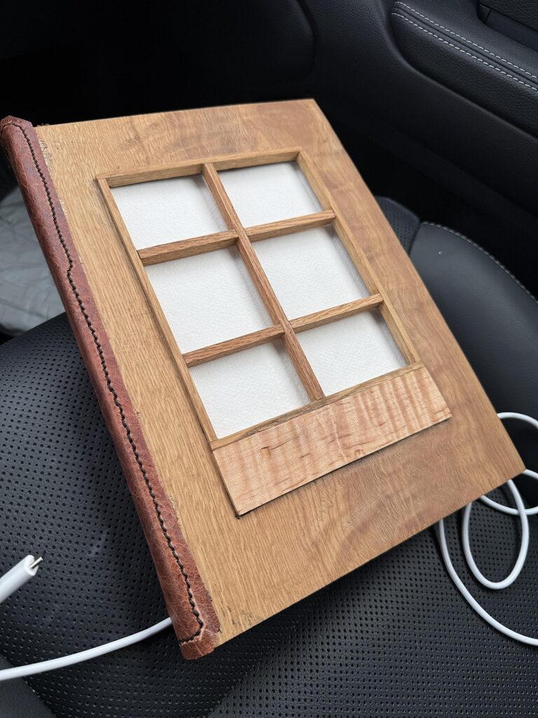 Handmade guest book with oak covers, leather spine, and a shoji-like window revealing white paper