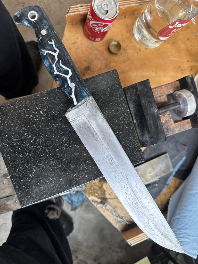 Large handmade Sabatier-style knife with patterned steel blade and black-and-white handle