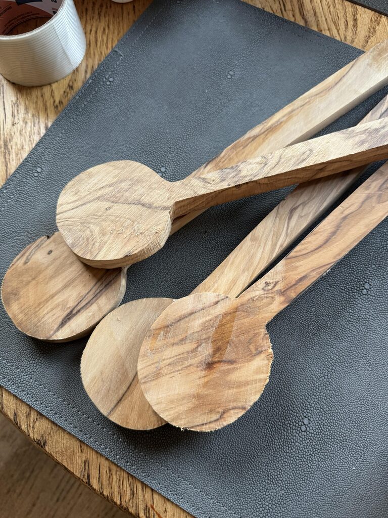 Olivewood salad spoon and fork blanks after being outlined and cut on the bandsaw