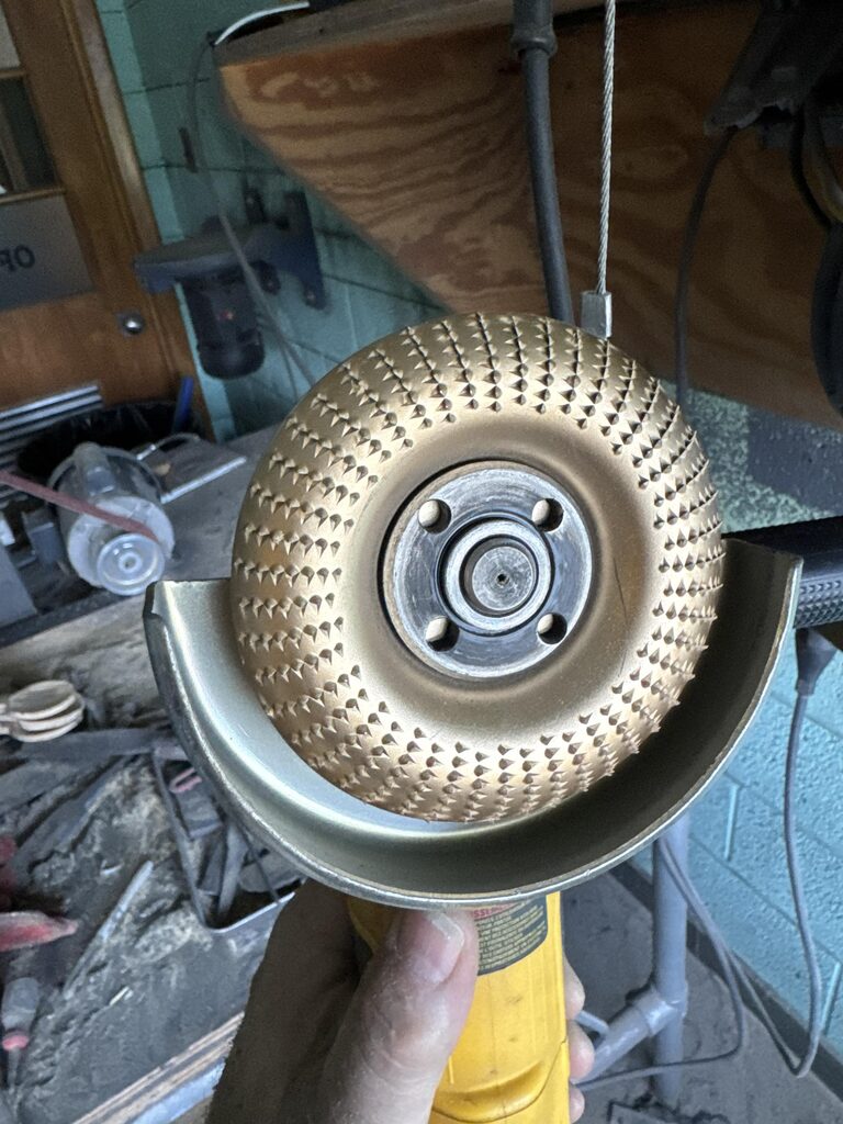 Carbide wood-carving disc mounted on an angle grinder