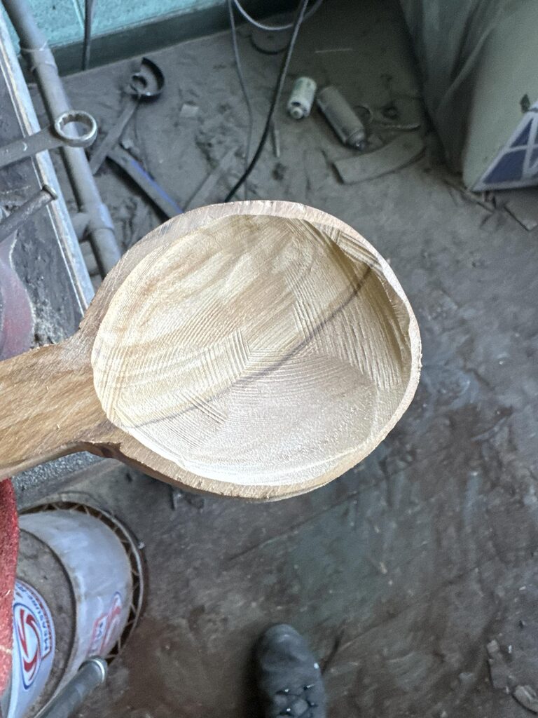 Olivewood spoon bowl freshly hollowed with coarse angle-grinder carving marks