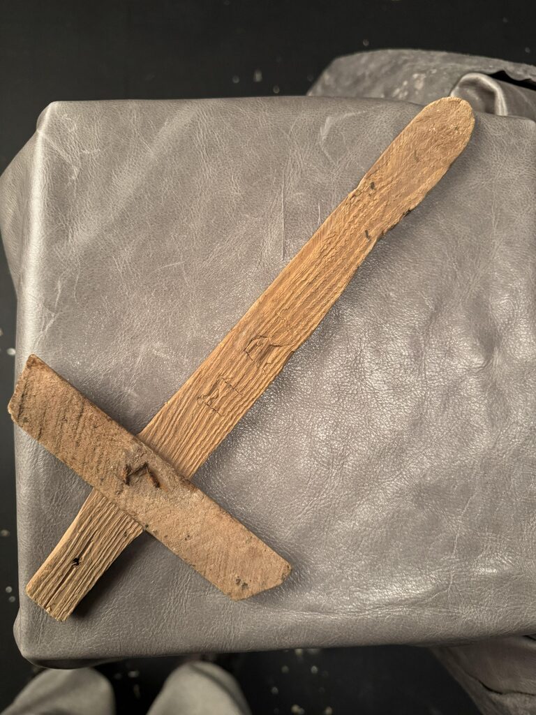 Childhood wooden sword made from lath with a simple crossguard fastened by recycled nails