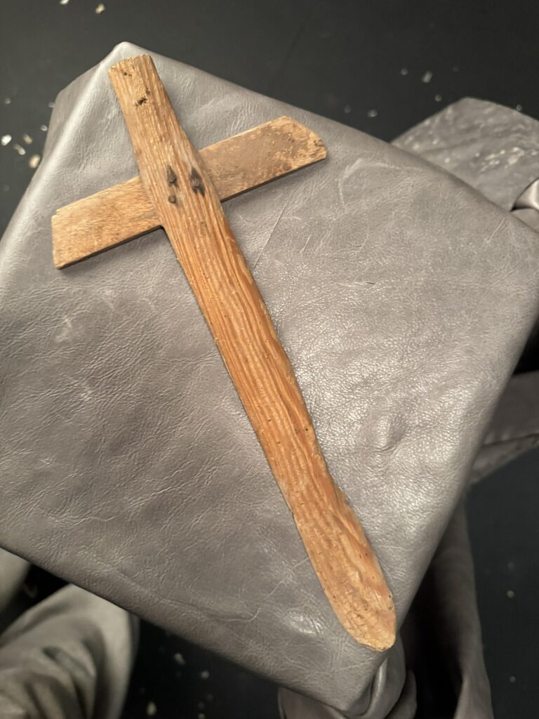 Reverse side of a childhood wooden sword showing plane marks and recycled nail fasteners